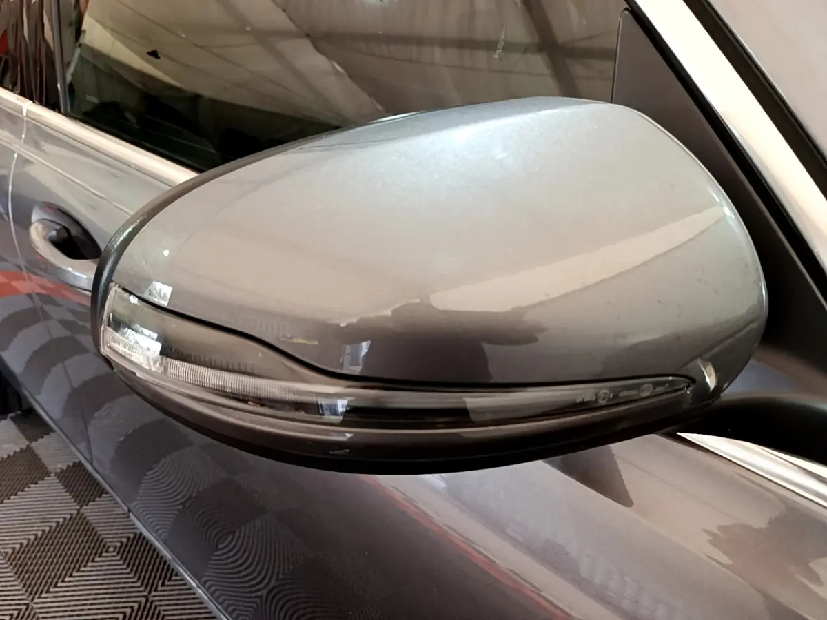 Gros plan sur le rétroviseur extérieur gris foncé côté conducteur du Mercedes GLB 200 d Business Line 2021.
