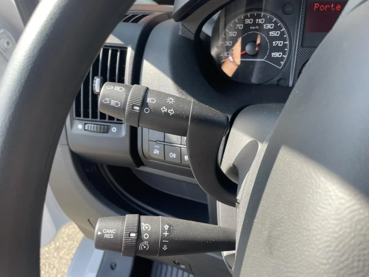 Vue rapprochée du volant et des commandes de régulateur de vitesse du Citroën Jumper blanc, avec tableau de bord partiel visible.