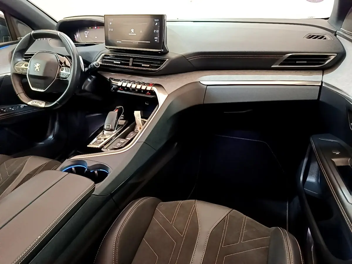 Vue intérieure avant droite du Peugeot 3008 GT Pack 2022 noir, volant cuir alu et écran tactile central visible.