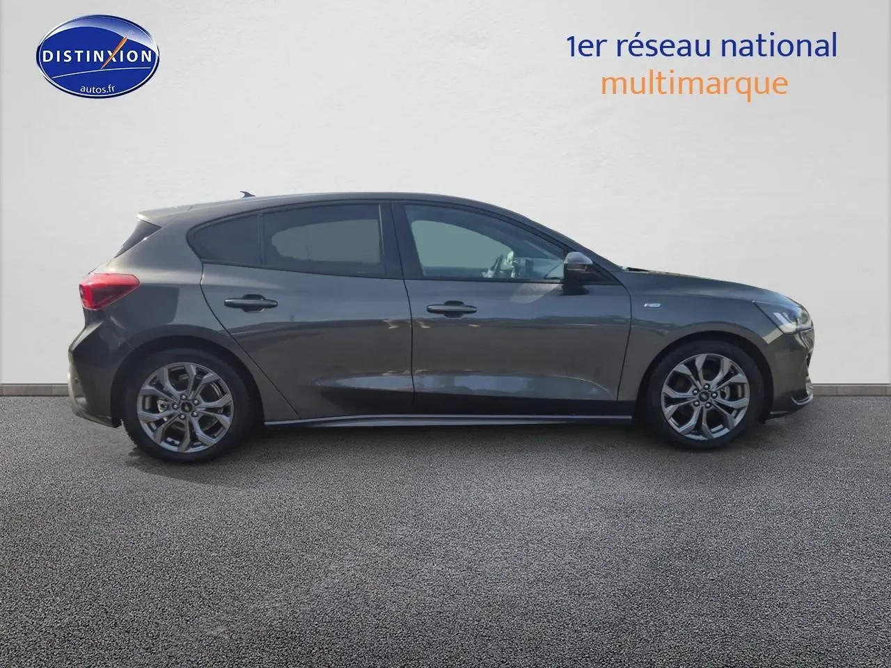 Profil côté gauche d'une Ford Focus 2024 gris magnétique avec jantes alliage et becquet arrière visible.