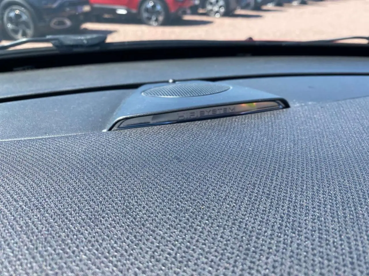 Gros plan sur le haut de la planche de bord avec haut-parleur HiFi System dans une DS3 essence rouge toit blanc.