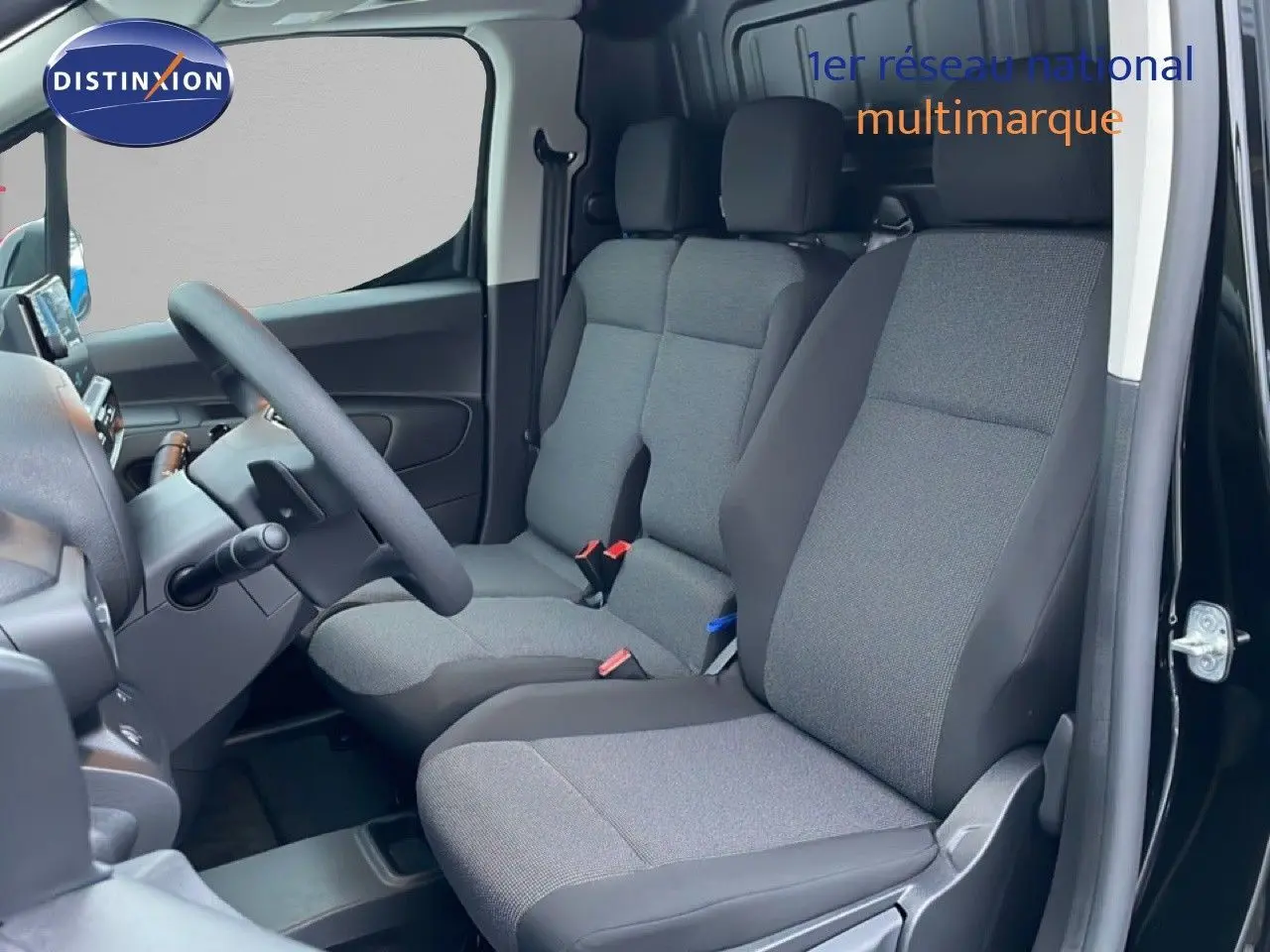 Vue intérieure côté conducteur du Citroën Berlingo Van XL noir Perla Metal, montrant les sièges avant en tissu gris et noir.