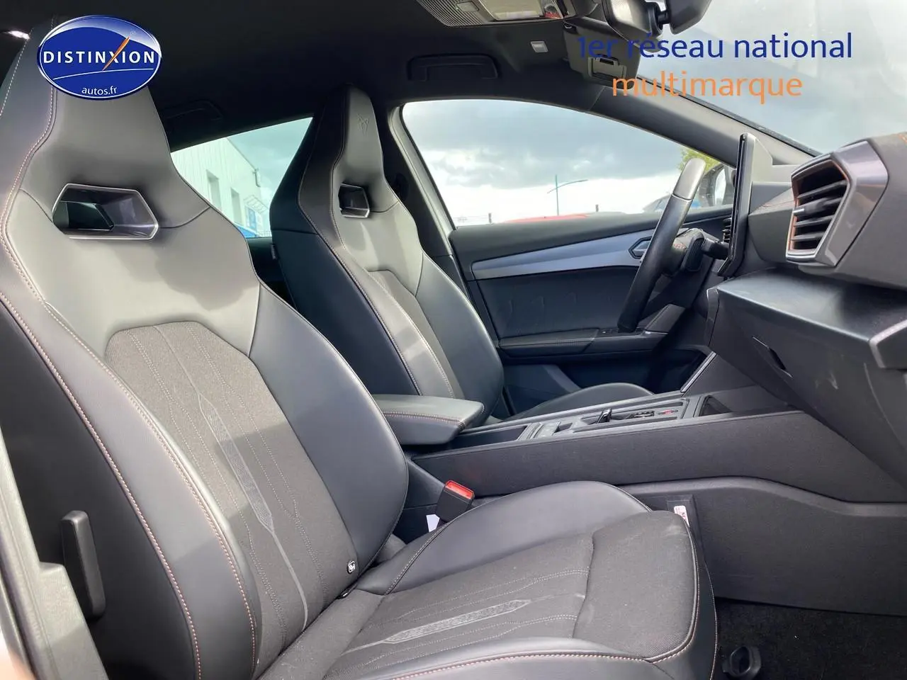 Intérieur côté droit de la CUPRA Formentor 2023, sièges sport en tissu noir et similicuir avec surpiqûres cuivre.