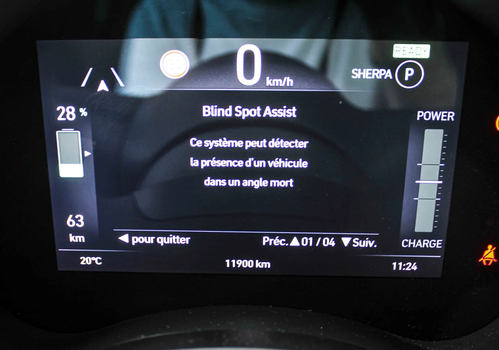 Écran numérique du tableau de bord de la Fiat 500 électrique affichant l'assistance angle mort et l'autonomie restante.