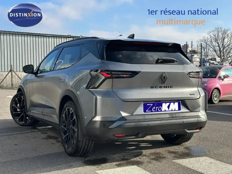 Vue 3/4 arrière droite du Renault Scénic E-Tech électrique gris schiste avec jantes noires et feux arrière LED distinctifs.