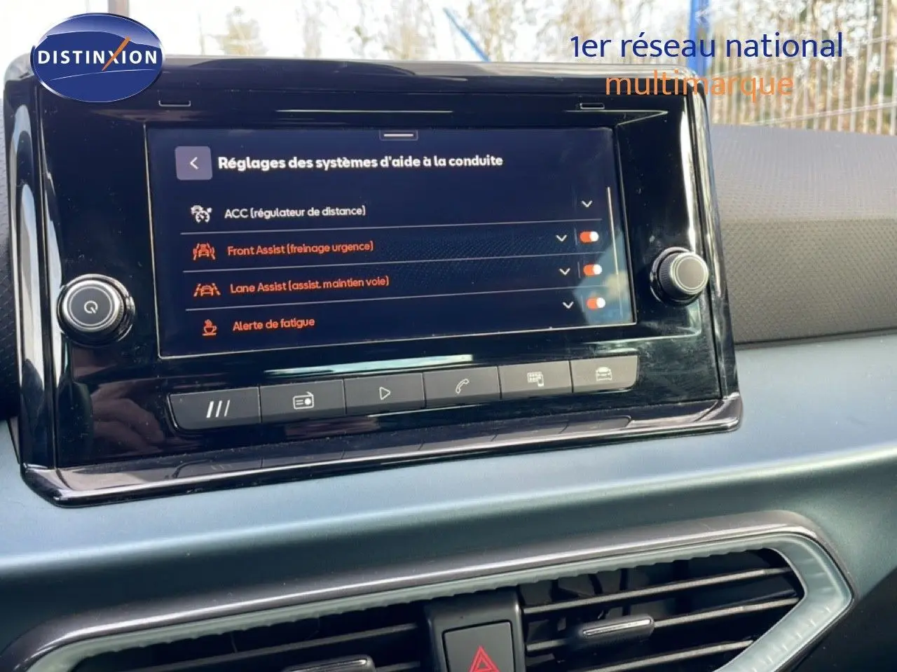 Écran tactile central affichant les réglages d’aide à la conduite dans l’habitacle du SEAT Arona blanc toit noir, vue de face.