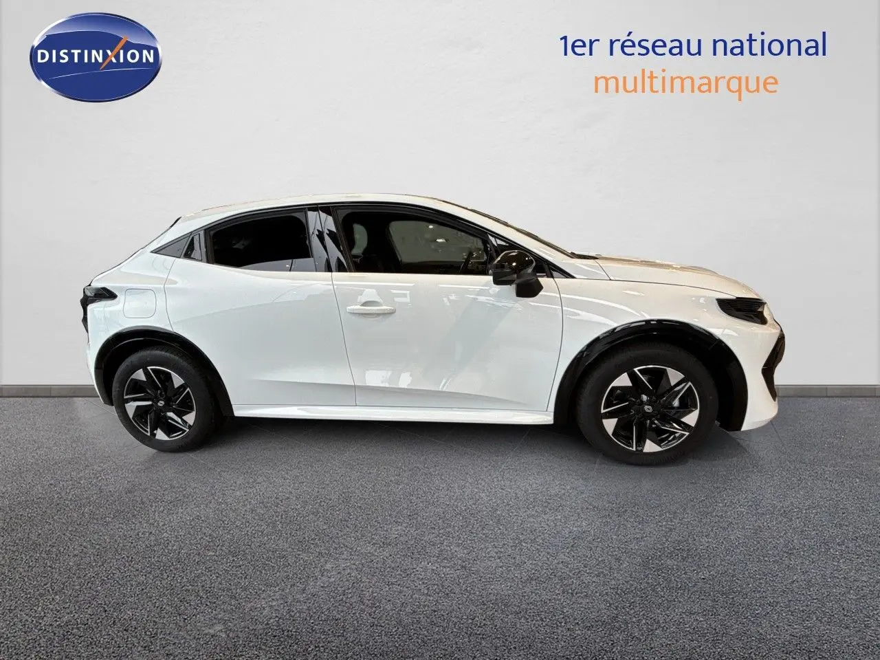 Profil droit de la Renault Clio VI TCe 115ch Techno blanche glacier, avec jantes noires et détails modernes.