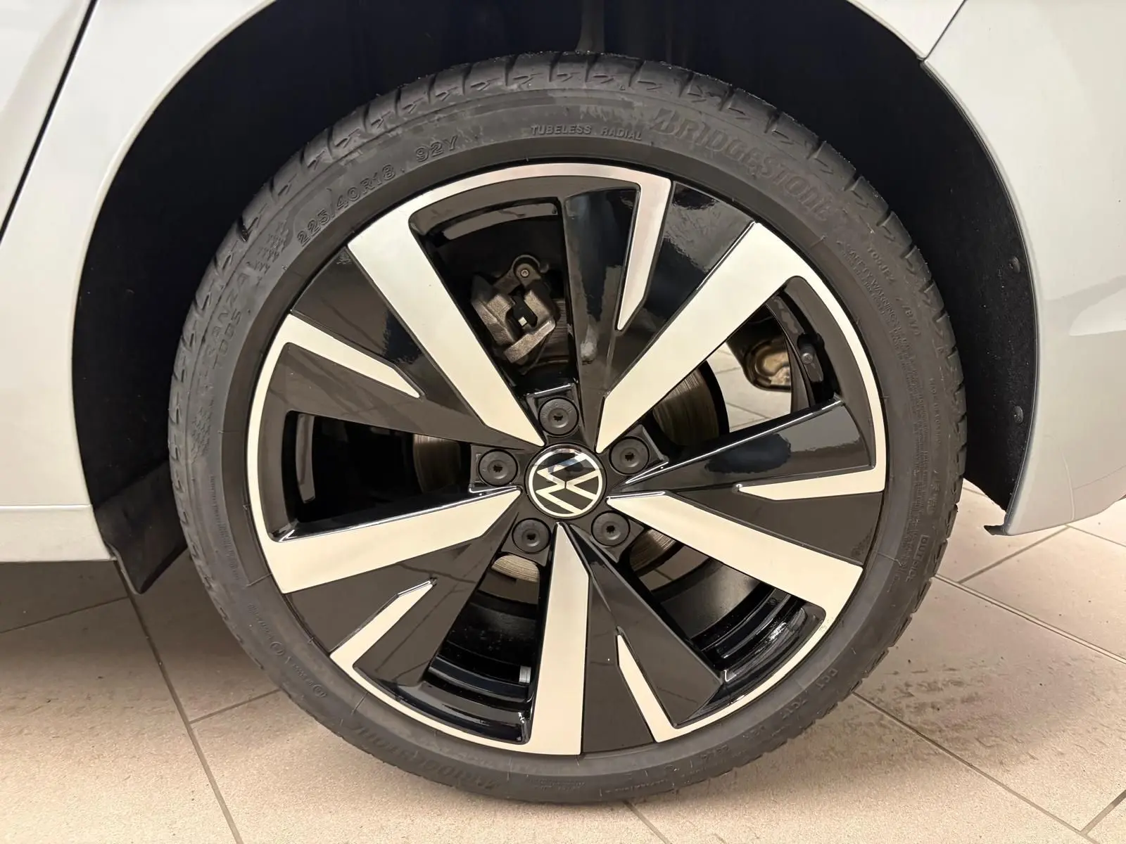 Gros plan sur la jante alliage 18'' Catania noire et argentée de la Volkswagen Golf 1.5 TSI 2025 couleur Argent Dolomite.