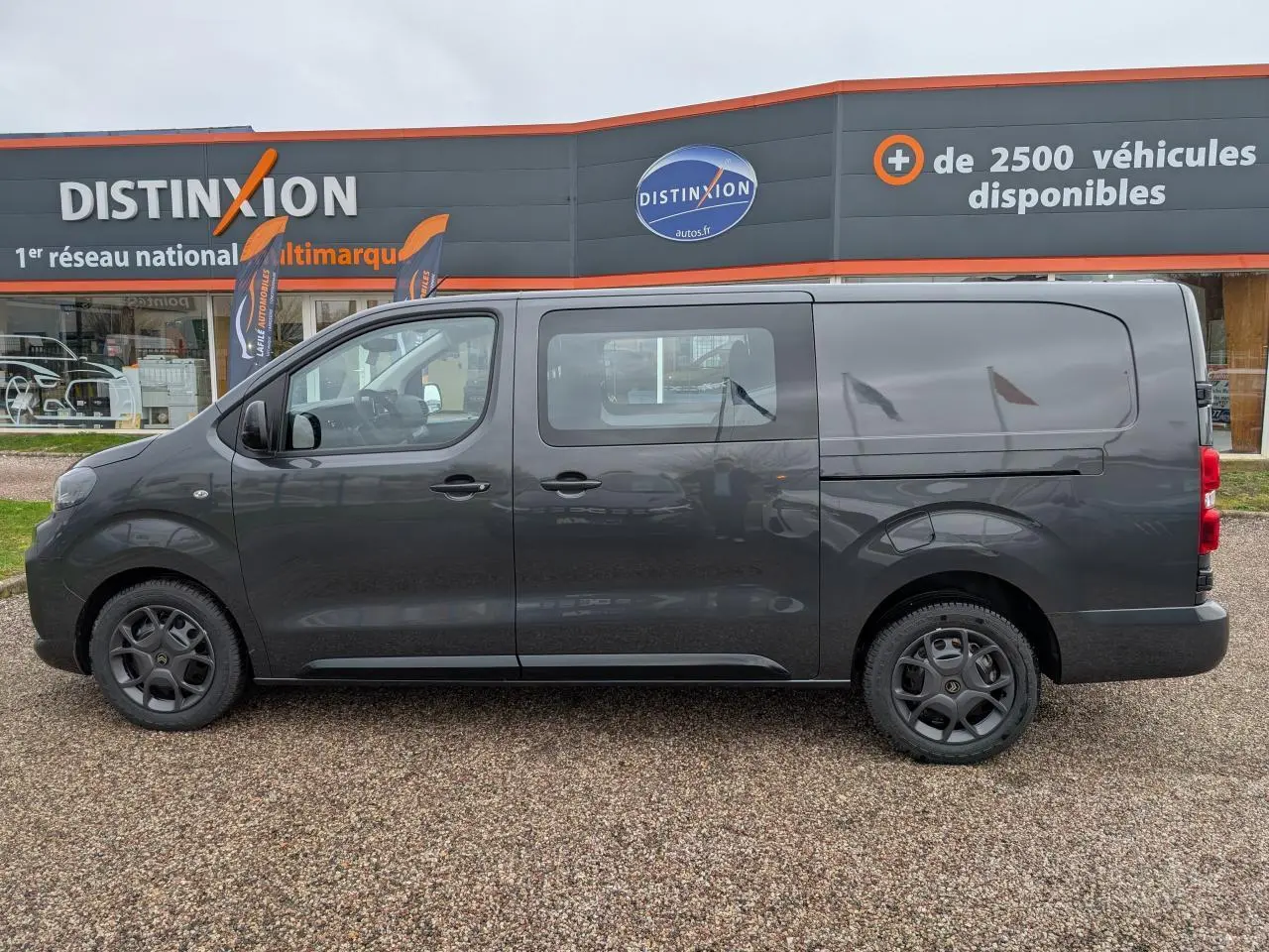 Profil côté gauche d’un Citroën Jumpy XL gris métallisé avec porte coulissante et roues tôles peintes.
