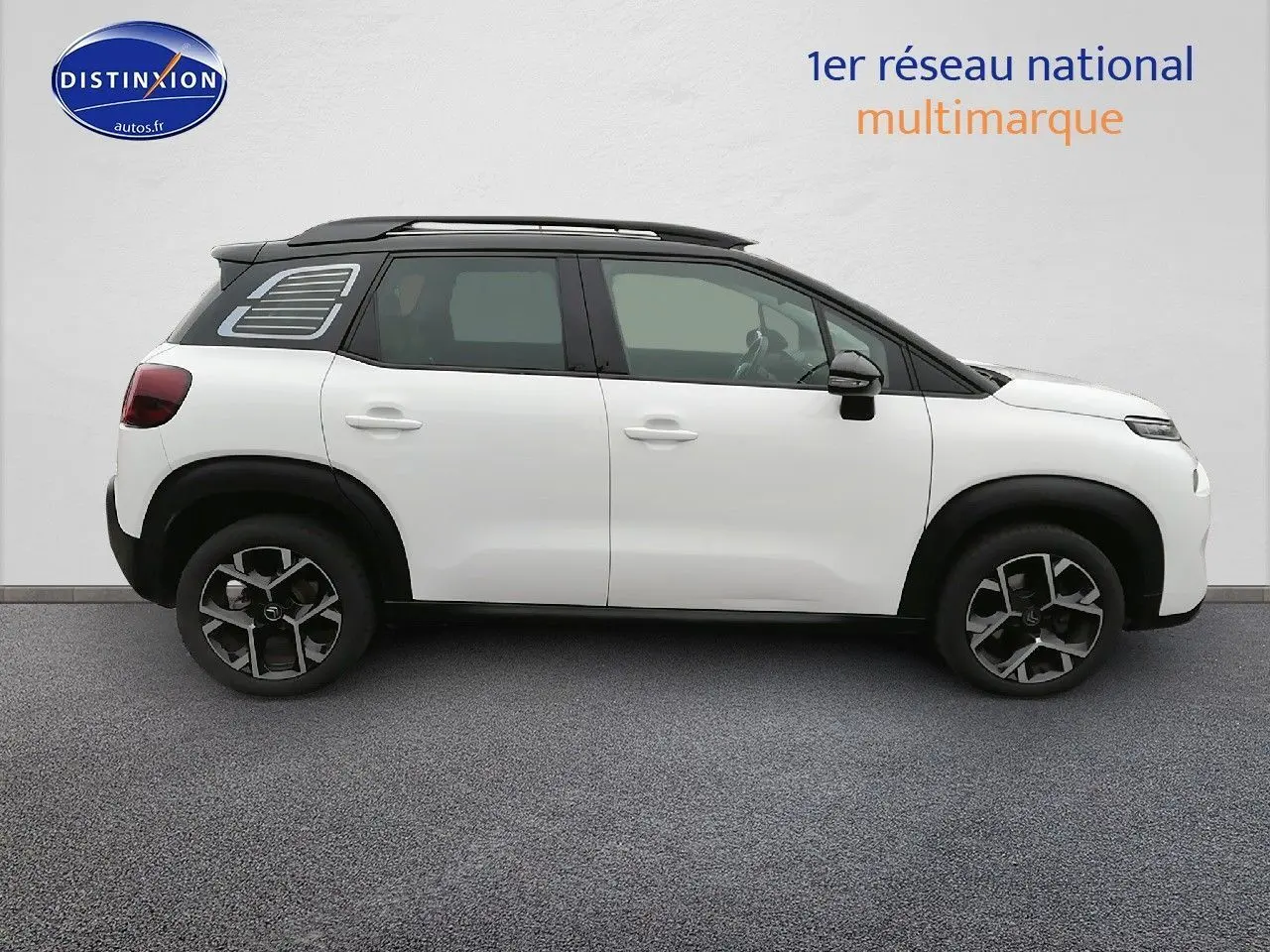 Profil côté gauche d'un Citroën C3 Aircross blanc polar avec toit noir et jantes bi-ton, sur fond neutre.