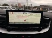 Écran tactile du système de navigation à bord d'une Kia Xceed blanche 1.6 GDI hybride rechargeable, vue intérieure frontale.