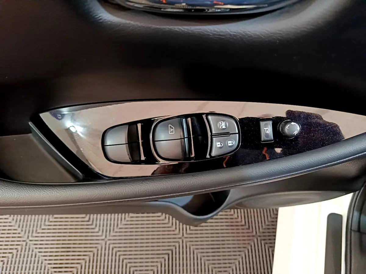 Panneau de commandes des vitres et rétroviseurs côté conducteur dans une Nissan Leaf blanche 2020 Business+