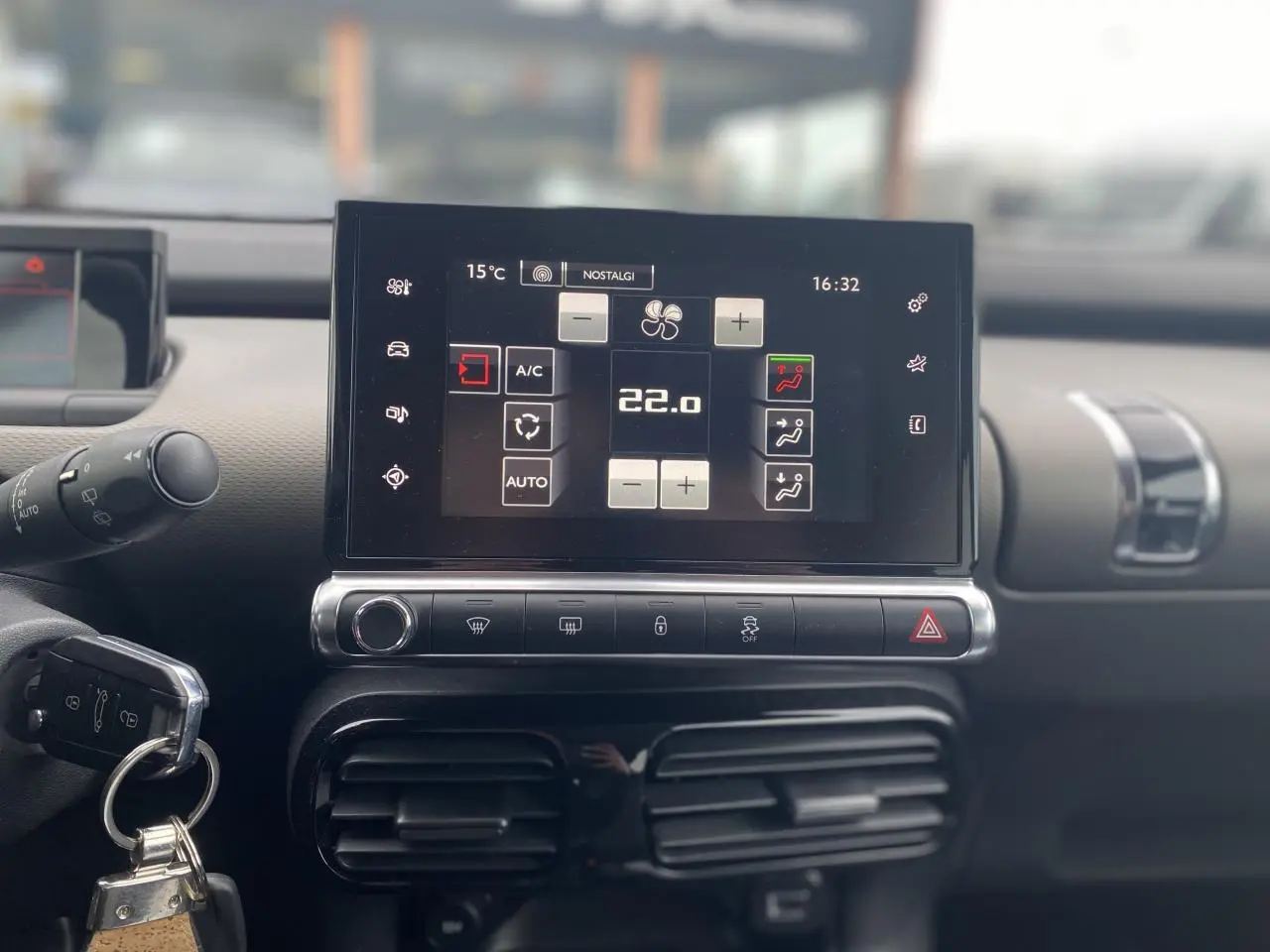 Vue rapprochée du tableau de bord de la Citroën C4 Cactus 2015, écran tactile affichant la climatisation à 22°C.