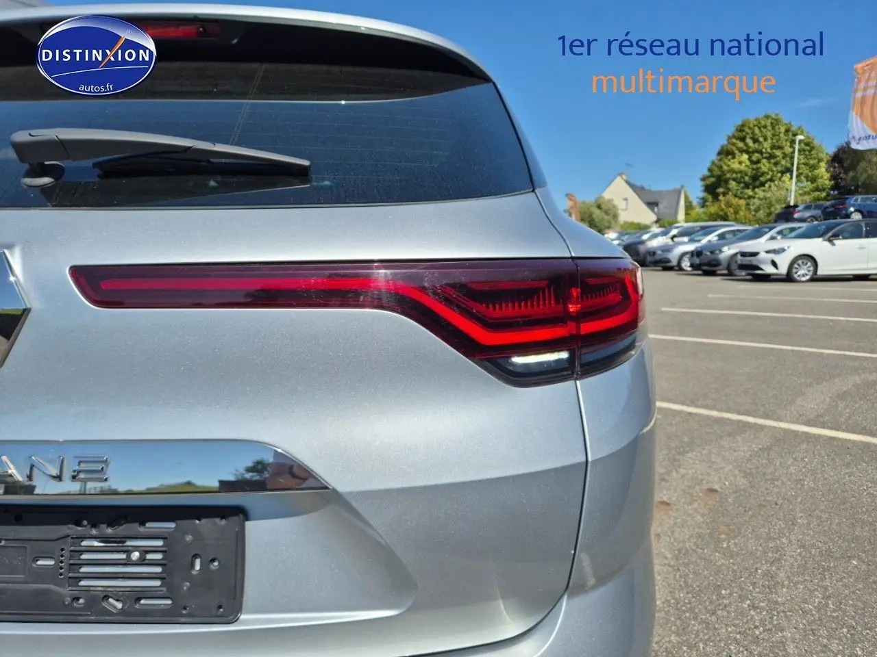 Vue arrière côté gauche du break Renault Mégane gris titanium 2024 avec feux arrière LED distinctifs.