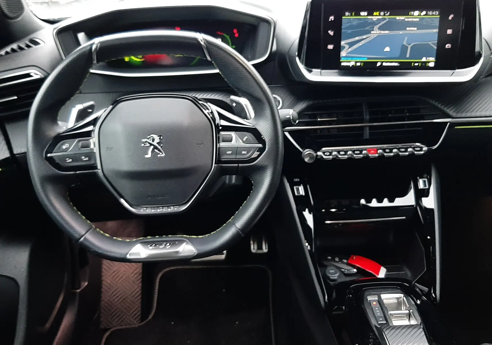 Vue intérieure avant du Peugeot 2008 1.2 PureTech 130ch GT 2023, tableau de bord noir avec écran tactile et volant compact.