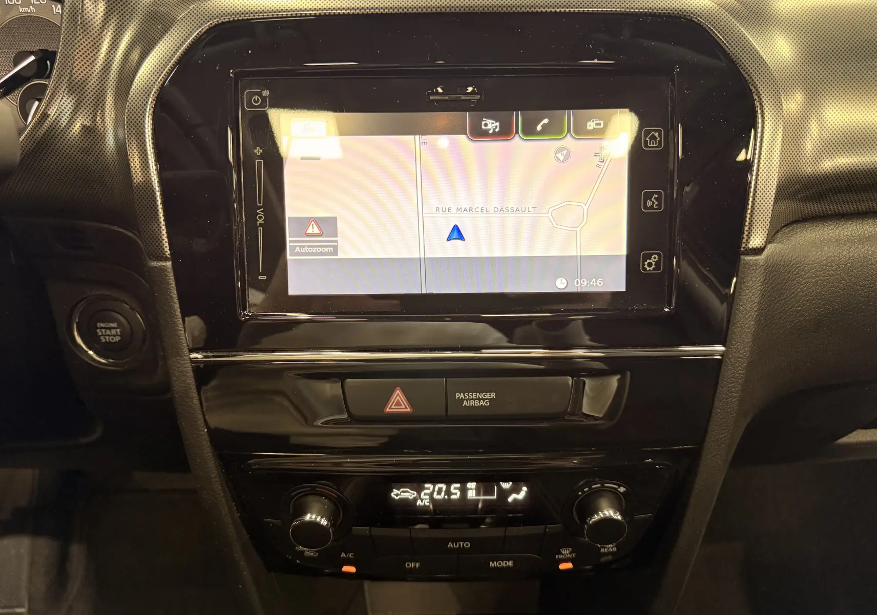 Vue rapprochée de la console centrale du Suzuki Vitara 2023, écran tactile avec navigation et commandes climatisation.