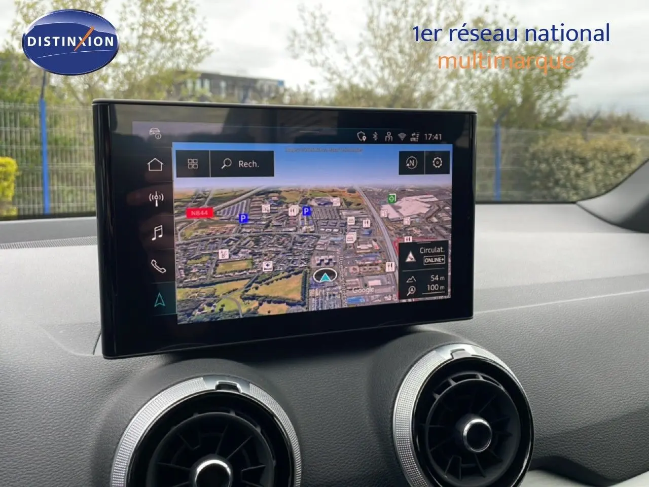 Vue avant intérieure du tableau de bord de l'Audi Q2 2025 avec écran tactile GPS et aérateurs ronds argentés.