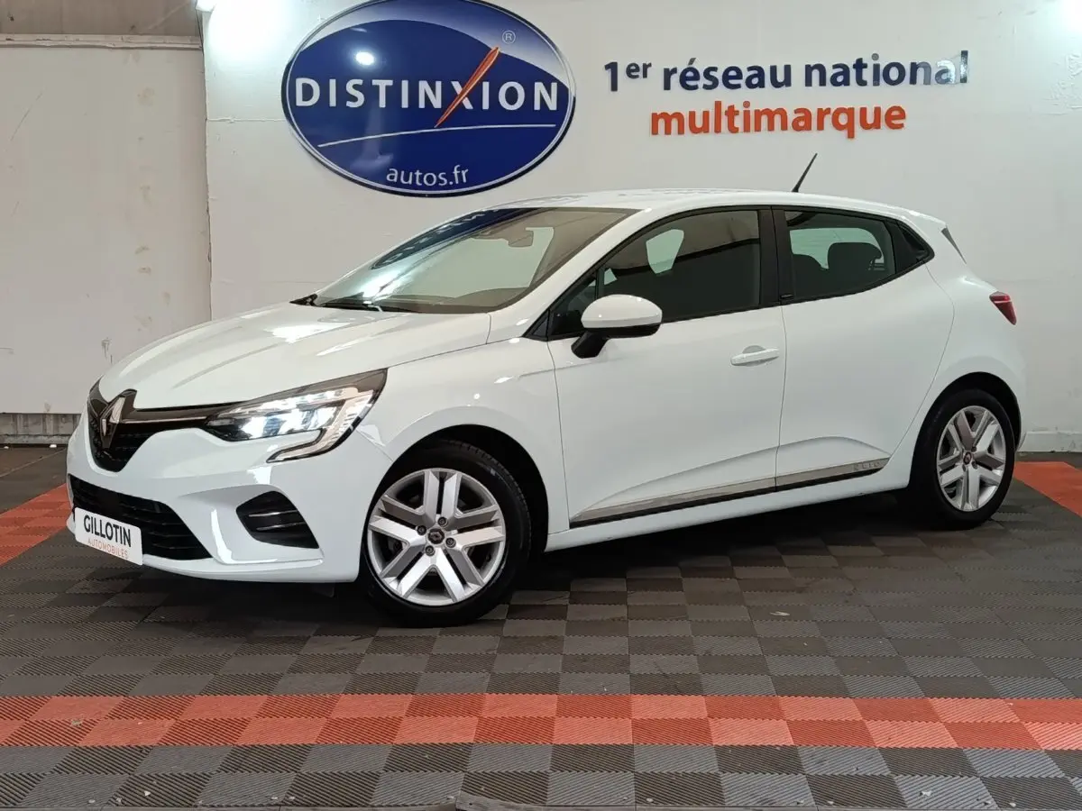 Renault Clio Business E-TECH 140 blanc vue de profil droit en intérieur avec jantes alliage et feux LED allumés.