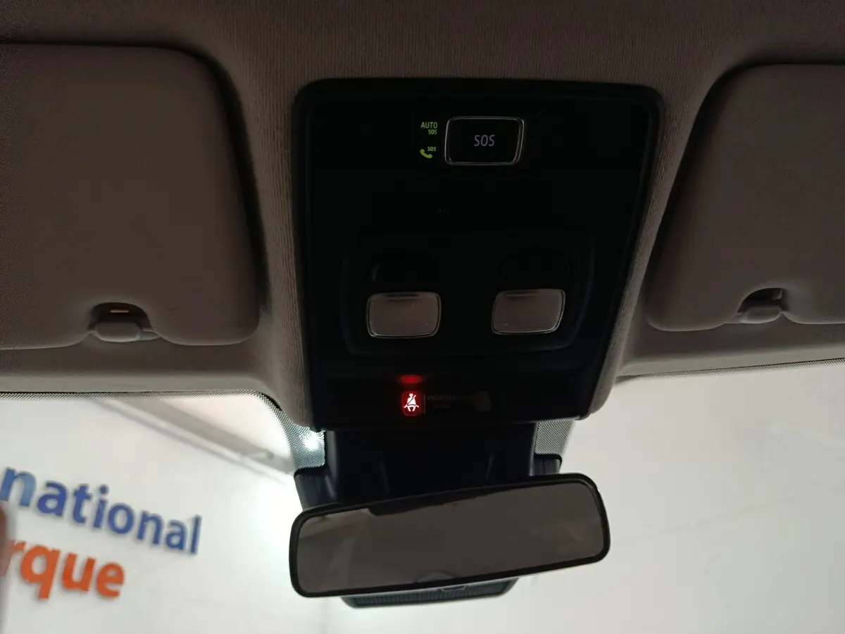 Vue intérieure du plafonnier avec commandes d’éclairage et bouton SOS allumé sur Renault Clio Business E-TECH 140 blanc.