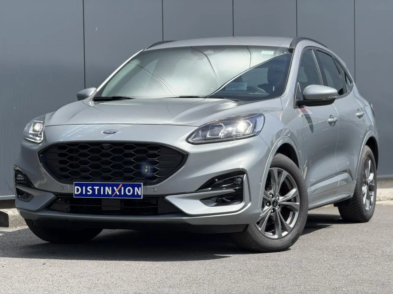 Vue 3/4 avant droit d'un Ford Kuga 2023 gris Solar avec calandre noire et jantes alliage 18 pouces finition ST-Line.
