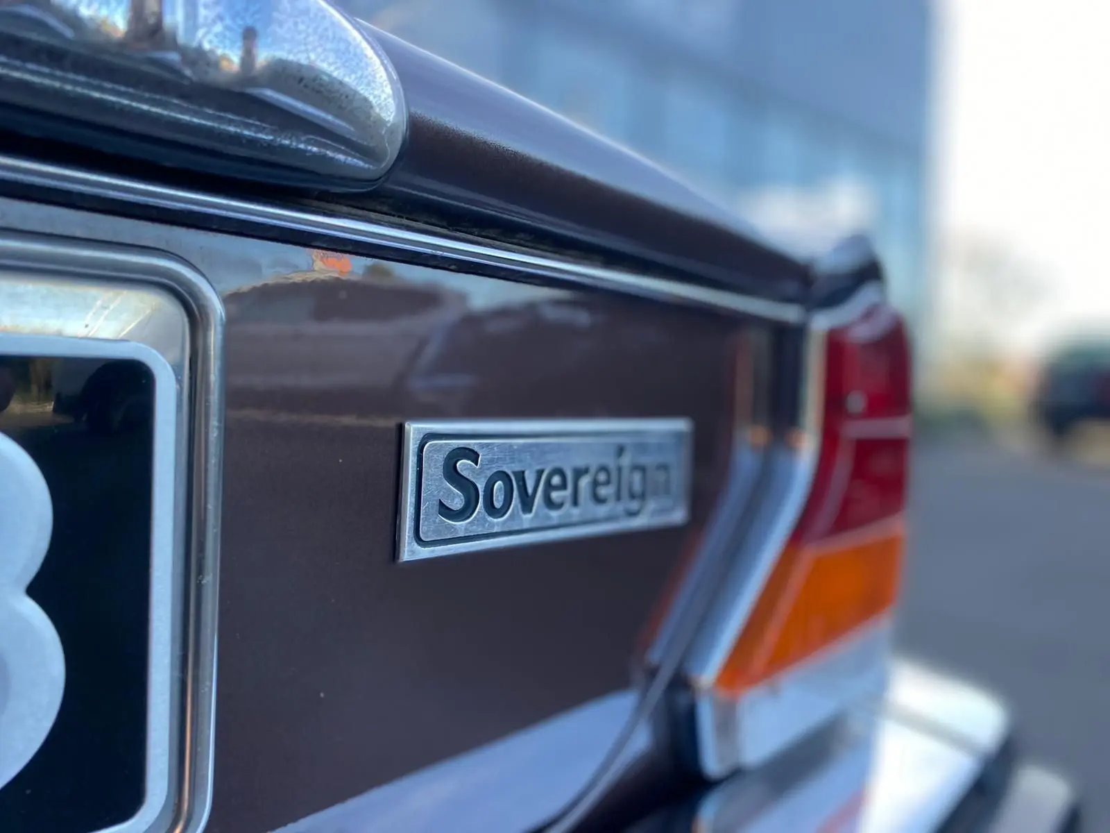 Gros plan sur l'arrière droit marron d'une Jaguar XJ6 Série 3 4.2 Sovereign de 1985 avec logo distinctif Sovereign.