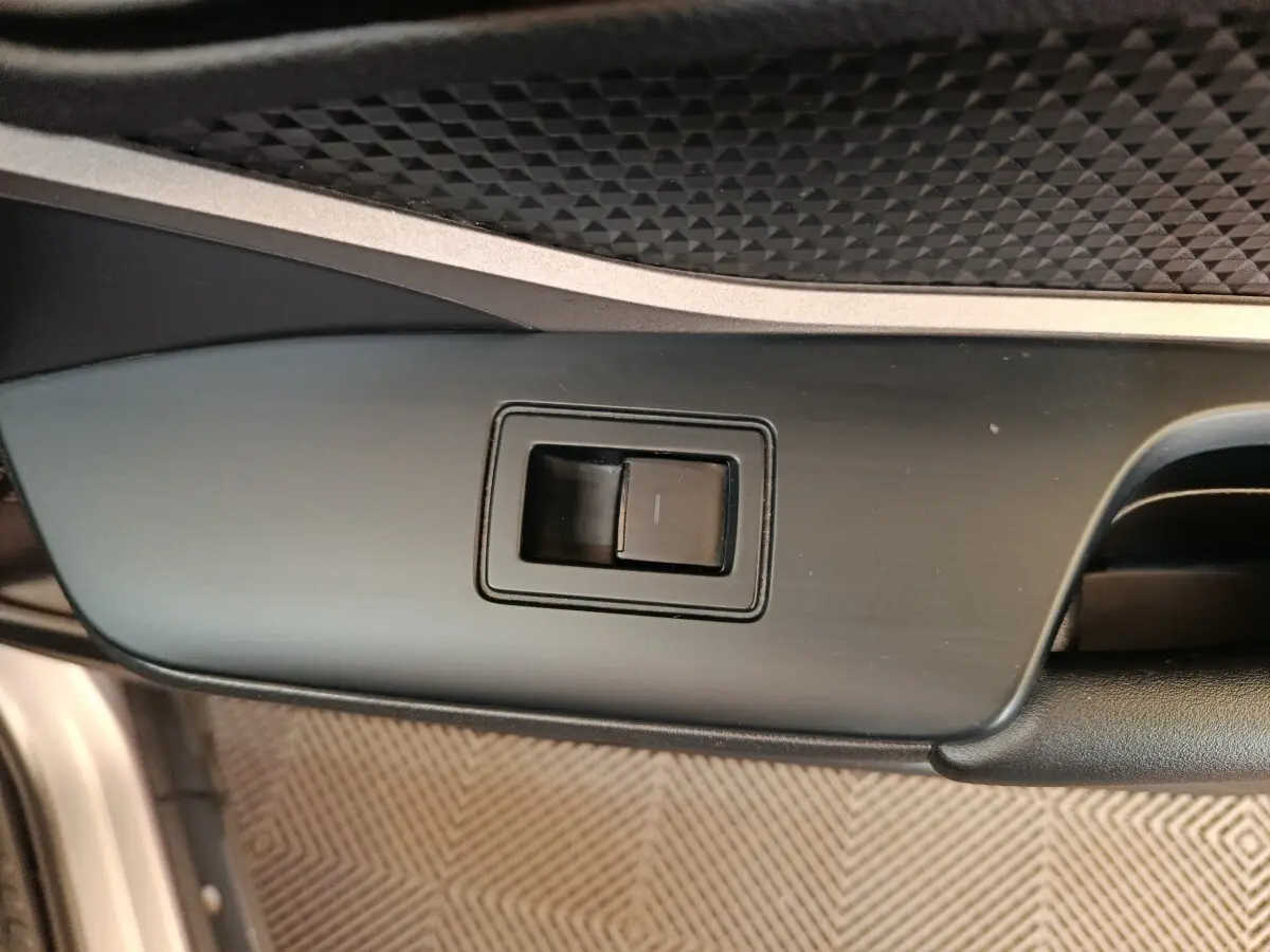 Détail du bouton de commande de la porte côté conducteur du Toyota C-HR gris clair 2022.