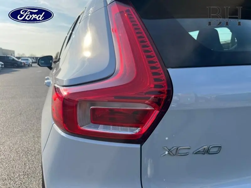 Gros plan sur le feu arrière droit du Volvo XC40 gris glacier, avec logo et badge XC40 visibles sur la carrosserie.