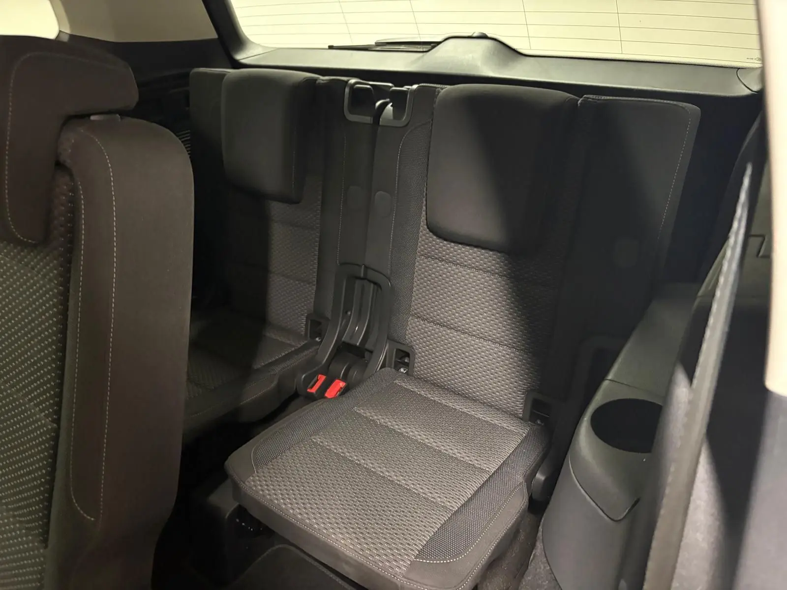 Vue rapprochée des sièges arrière rabattables en tissu gris du Volkswagen Touran 2024, version 7 places.