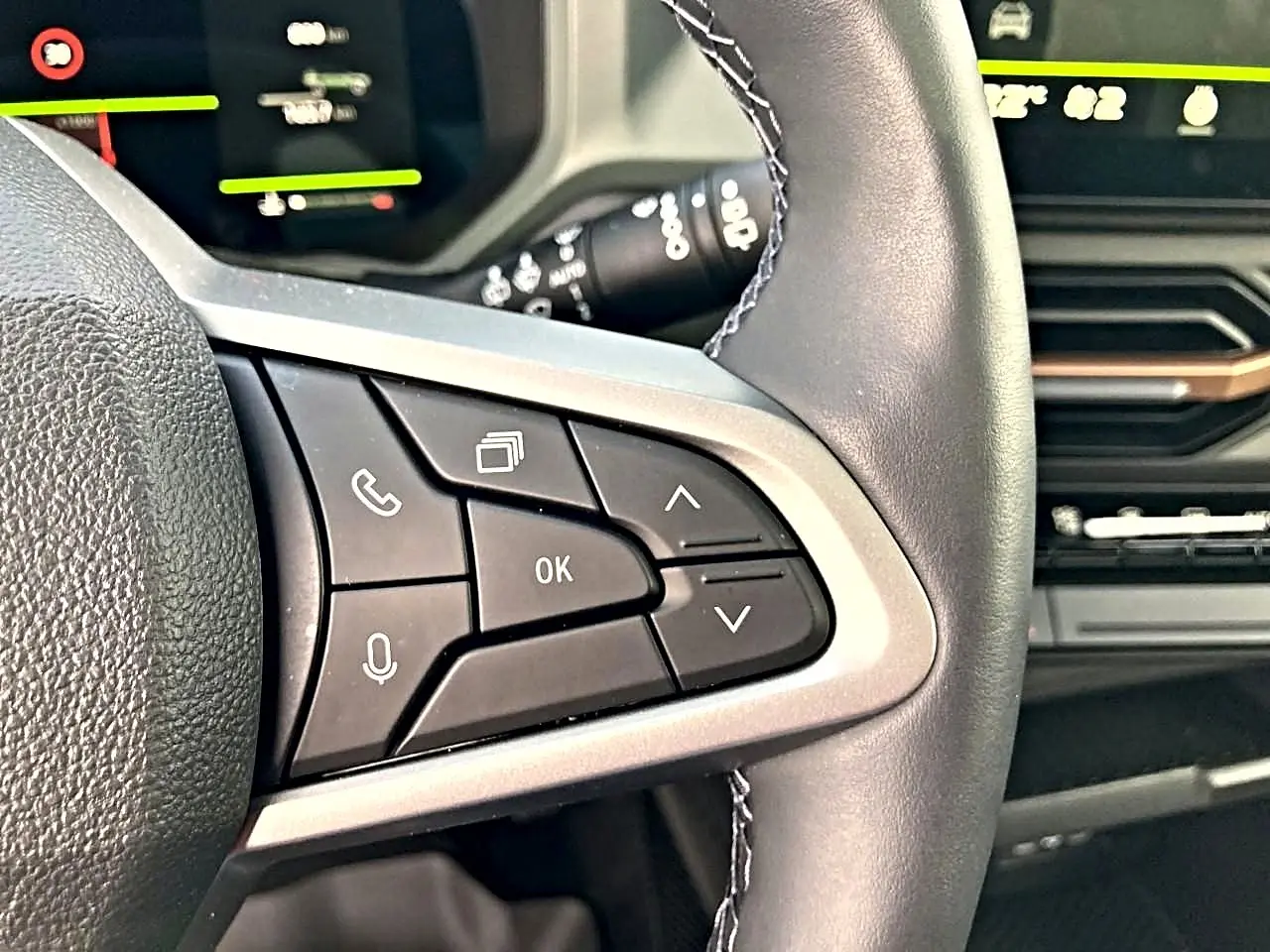 Gros plan sur les commandes multifonctions noires à gauche du volant du Dacia Bigster 2025, intérieur moderne.