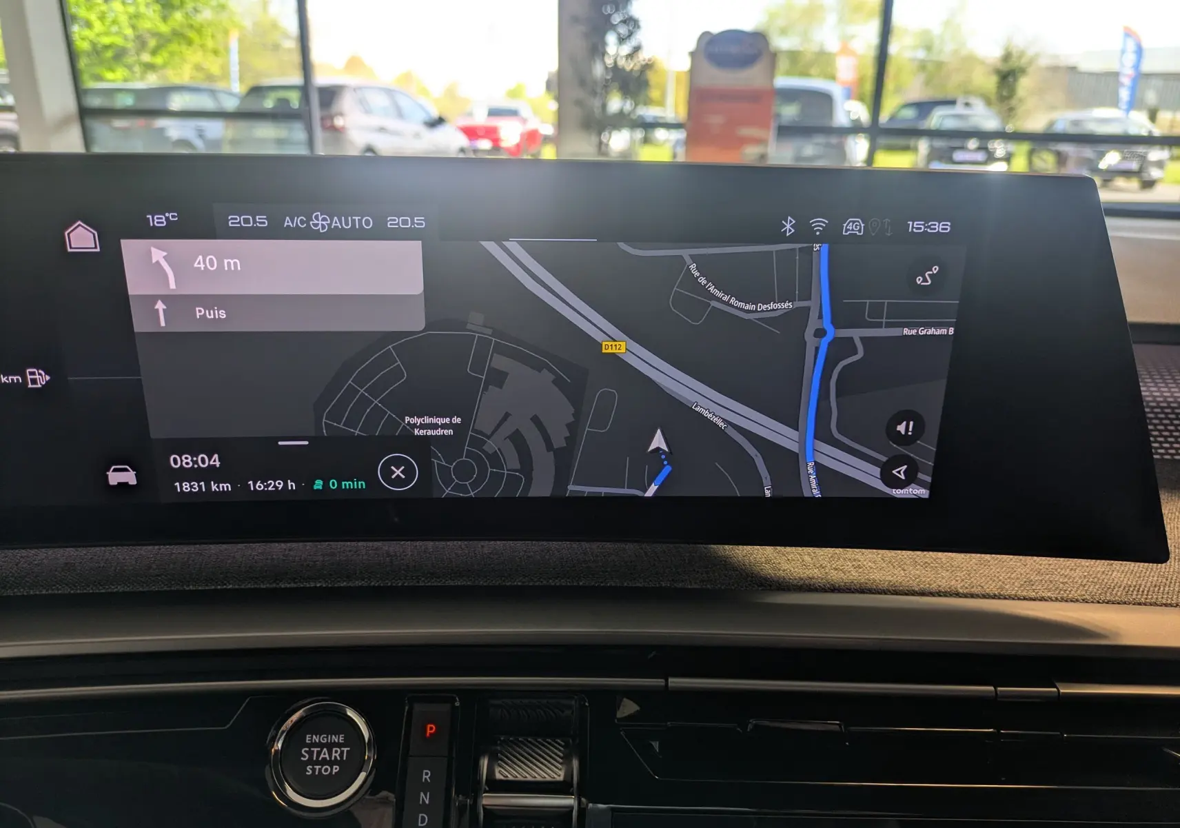 Écran tactile du GPS et bouton start/stop du tableau de bord intérieur du Peugeot 5008 Hybrid blanc.