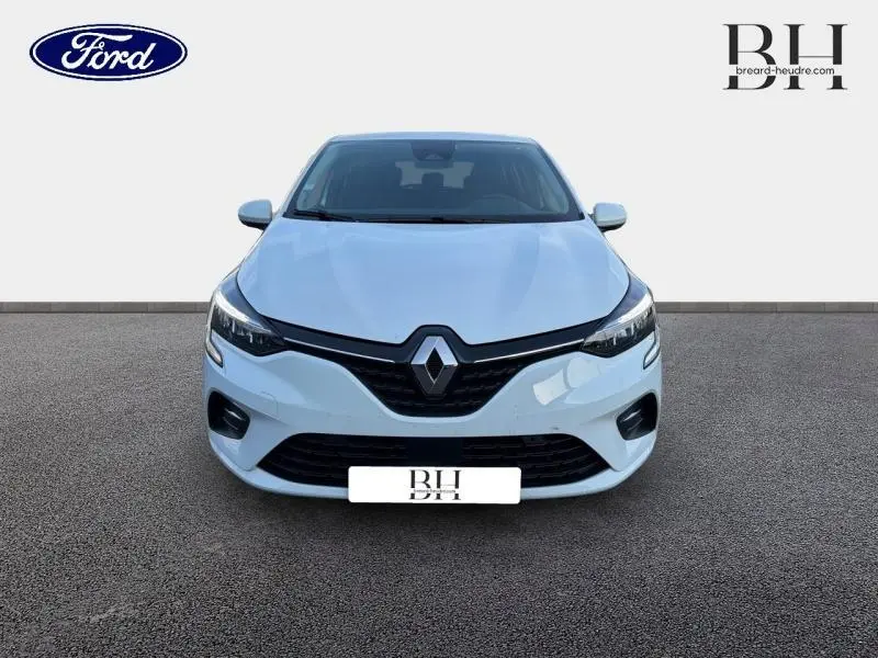 Renault Clio blanc vue de face, mettant en valeur la calandre noire et les phares LED modernes.