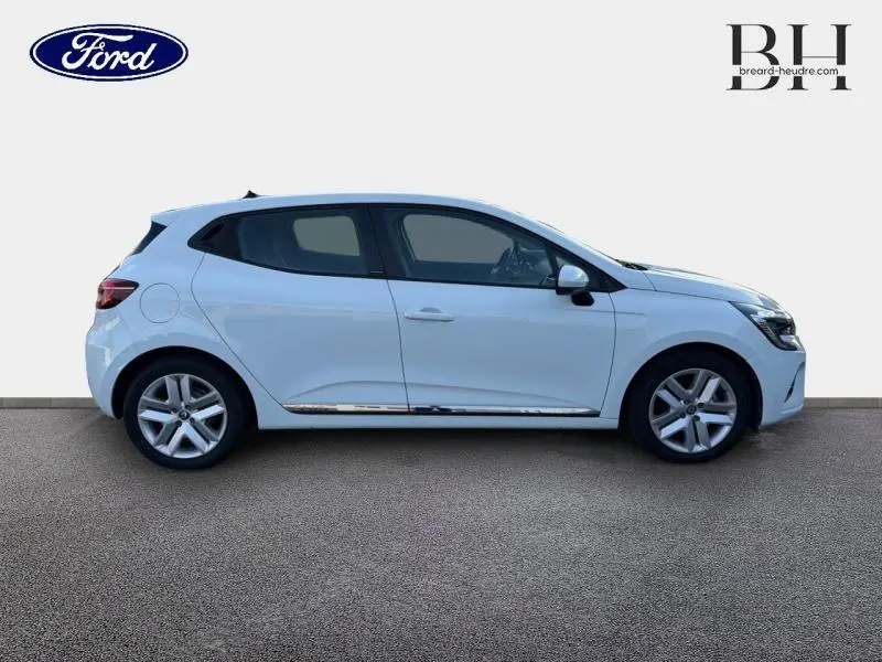 Profil droit d'une Renault Clio blanche 2021 avec jantes alliage et baguette chromée sur porte.