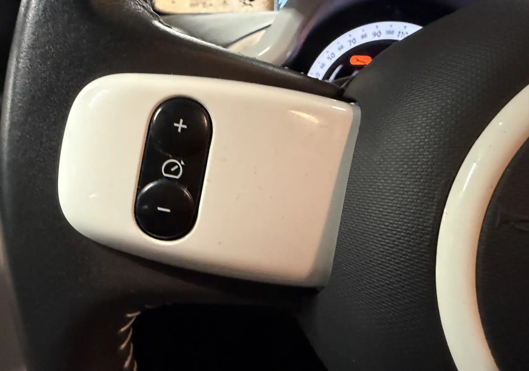 Gros plan sur le volant cuir gris et ses commandes de régulateur de vitesse de la Renault Twingo III 2018.
