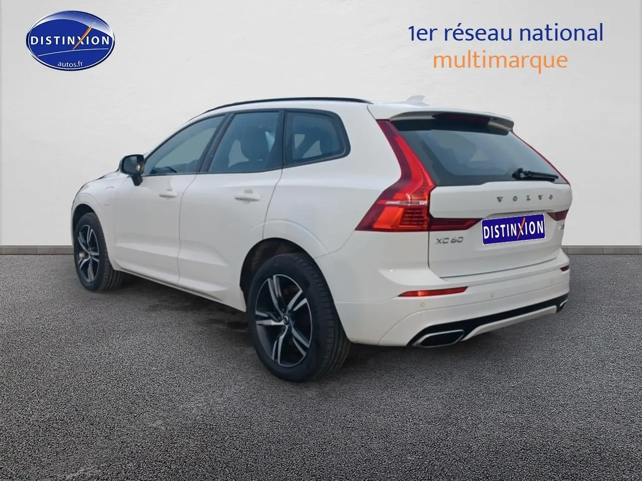 Vue 3/4 arrière droite d’un Volvo XC60 blanc avec feux arrière LED et jantes alliage noires.