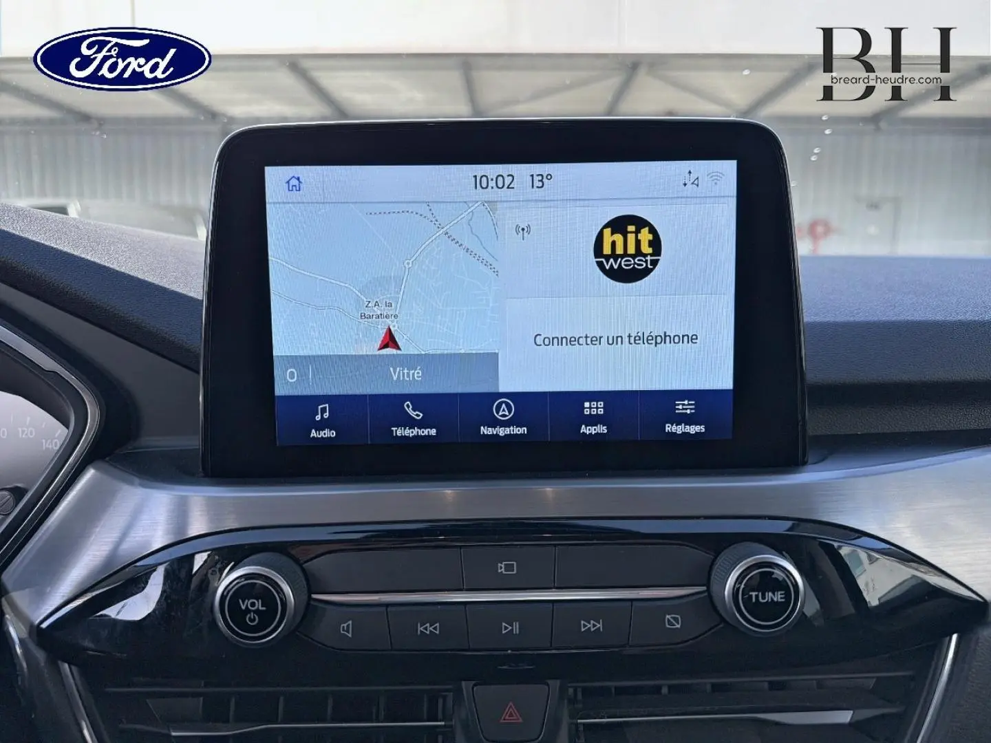 Vue rapprochée de l’écran tactile multimédia et de la console centrale du Ford Kuga blanc Glacier, version Titanium 2021.