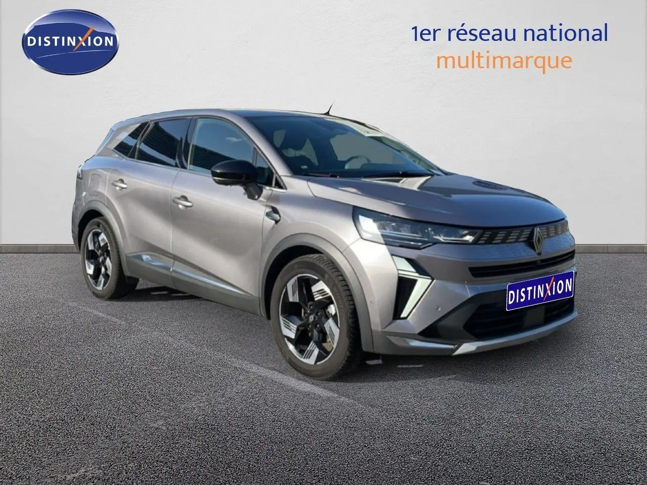 Vue 3/4 avant droit d'une Renault Symbioz gris cassiopée métal avec jantes bicolores et calandre distinctive.