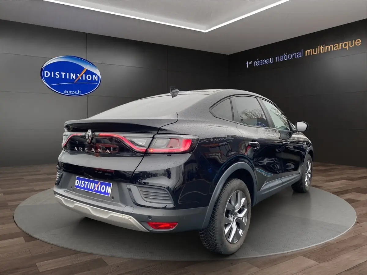 Vue 3/4 arrière droite du Renault Arkana noir 2024 avec feux arrière LED et jantes alliage visibles en showroom.
