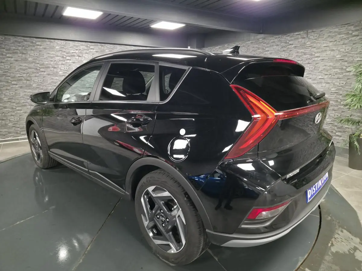 Vue 3/4 arrière droite d'une Hyundai Bayon noire avec feux arrière LED en forme de boomerang et jantes alliage 17 pouces.