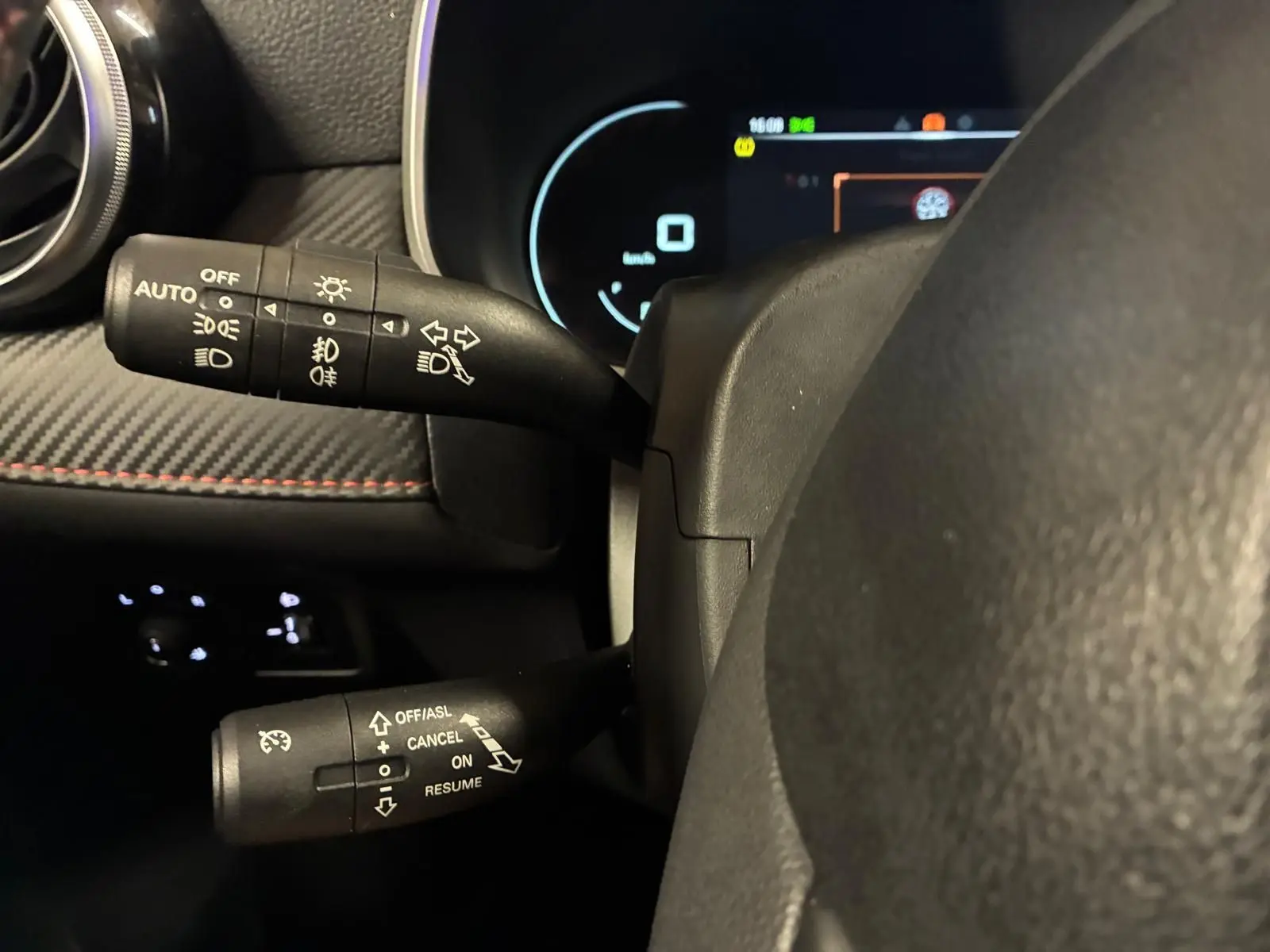 Gros plan sur les commandes au volant du MG ZS 2022, avec tableau de bord numérique et finitions intérieures noires.