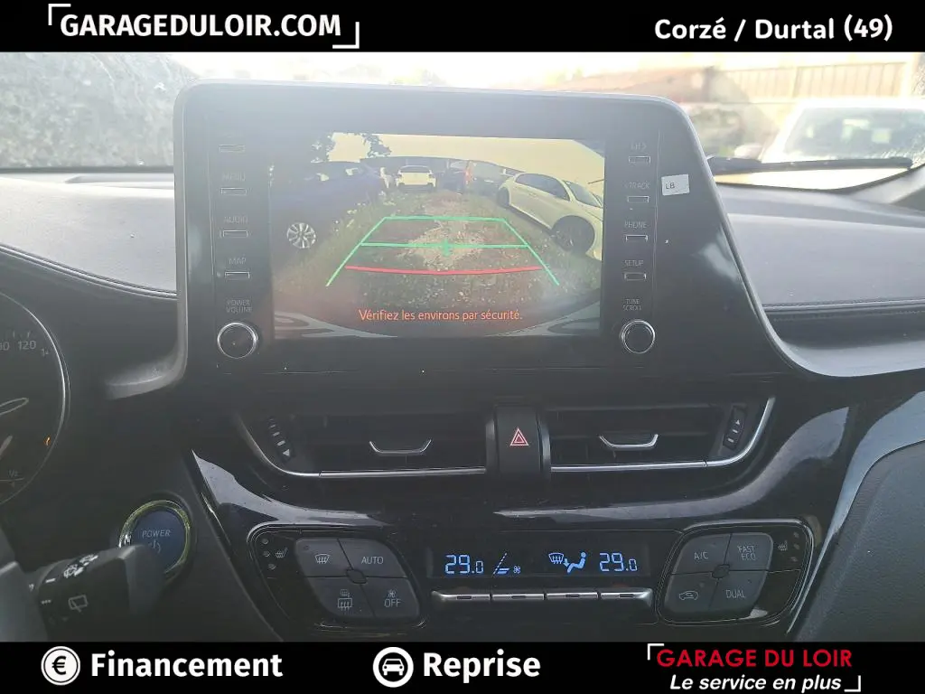 Vue intérieure du tableau de bord du Toyota C-HR 1.8 Hybride 2023 avec écran tactile affichant la caméra de recul.