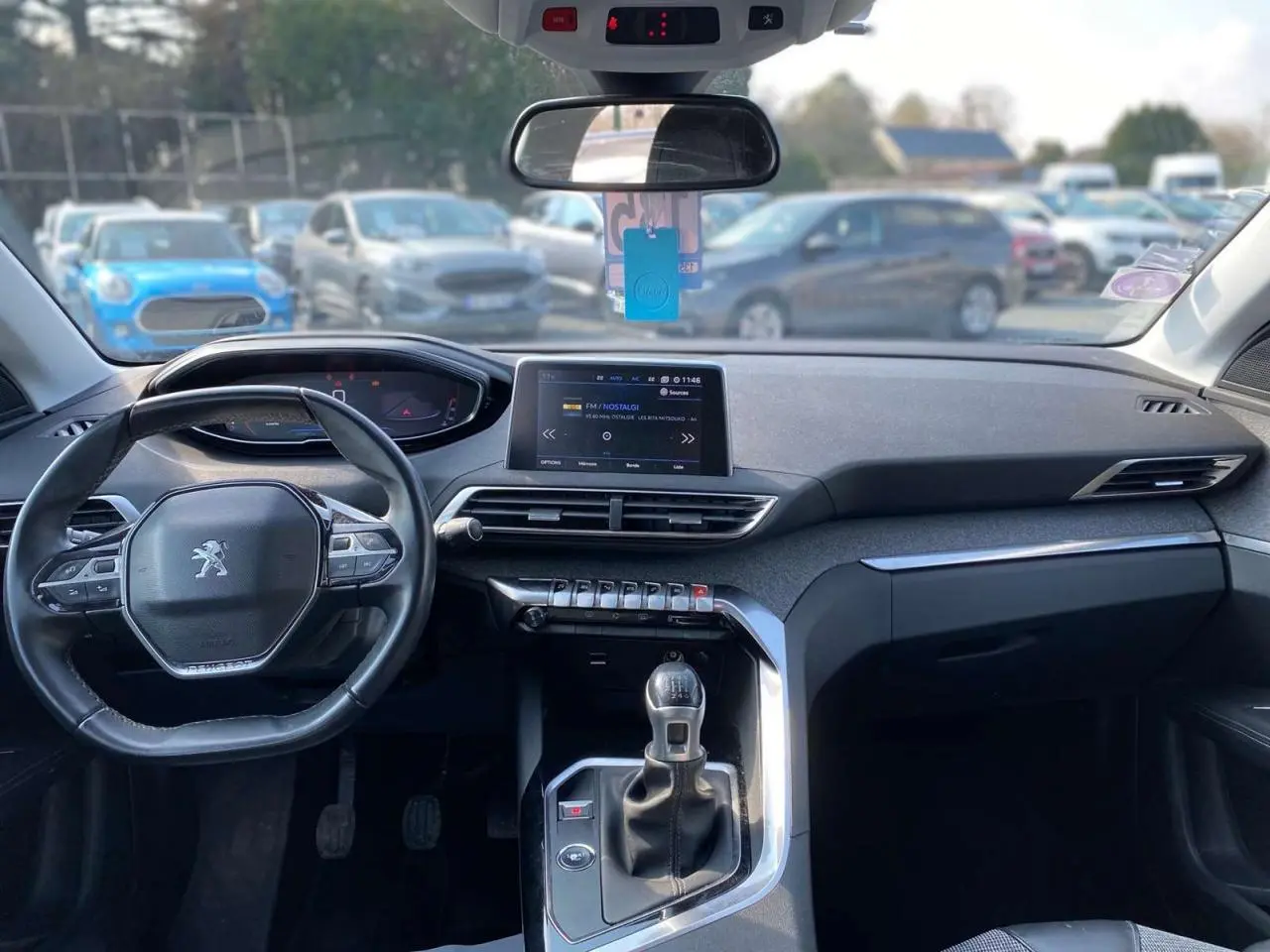 Vue intérieure avant du Peugeot 3008 blanc de 2018, mettant en valeur le tableau de bord et la boîte manuelle.