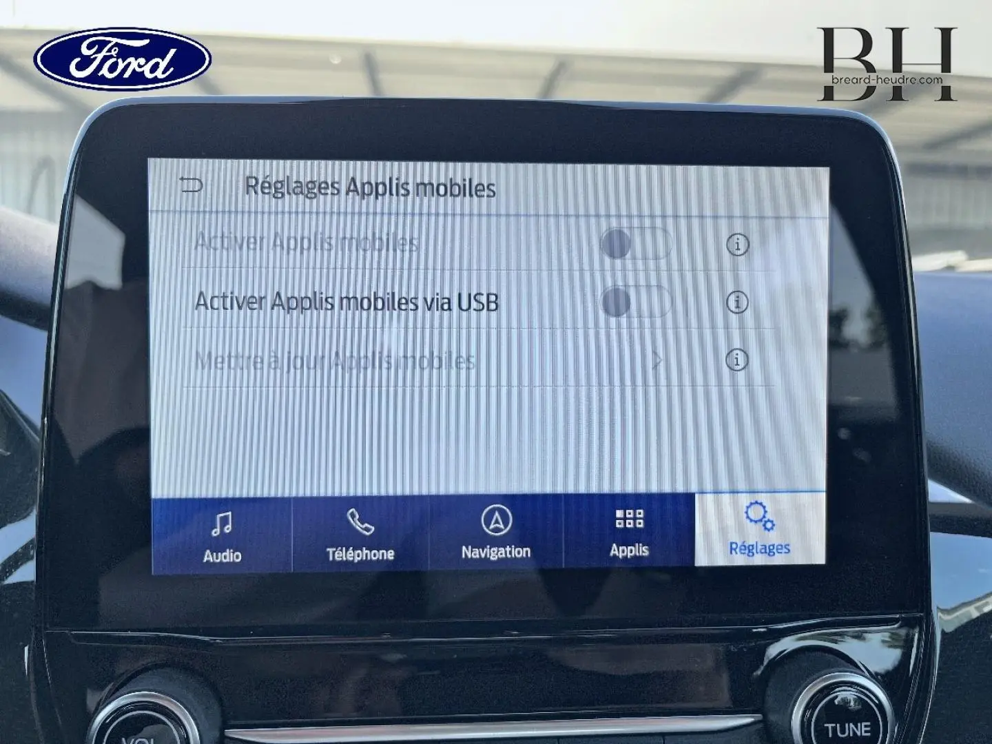 Écran tactile central du Ford Puma 2022 affichant les réglages des applications mobiles, intérieur noir.