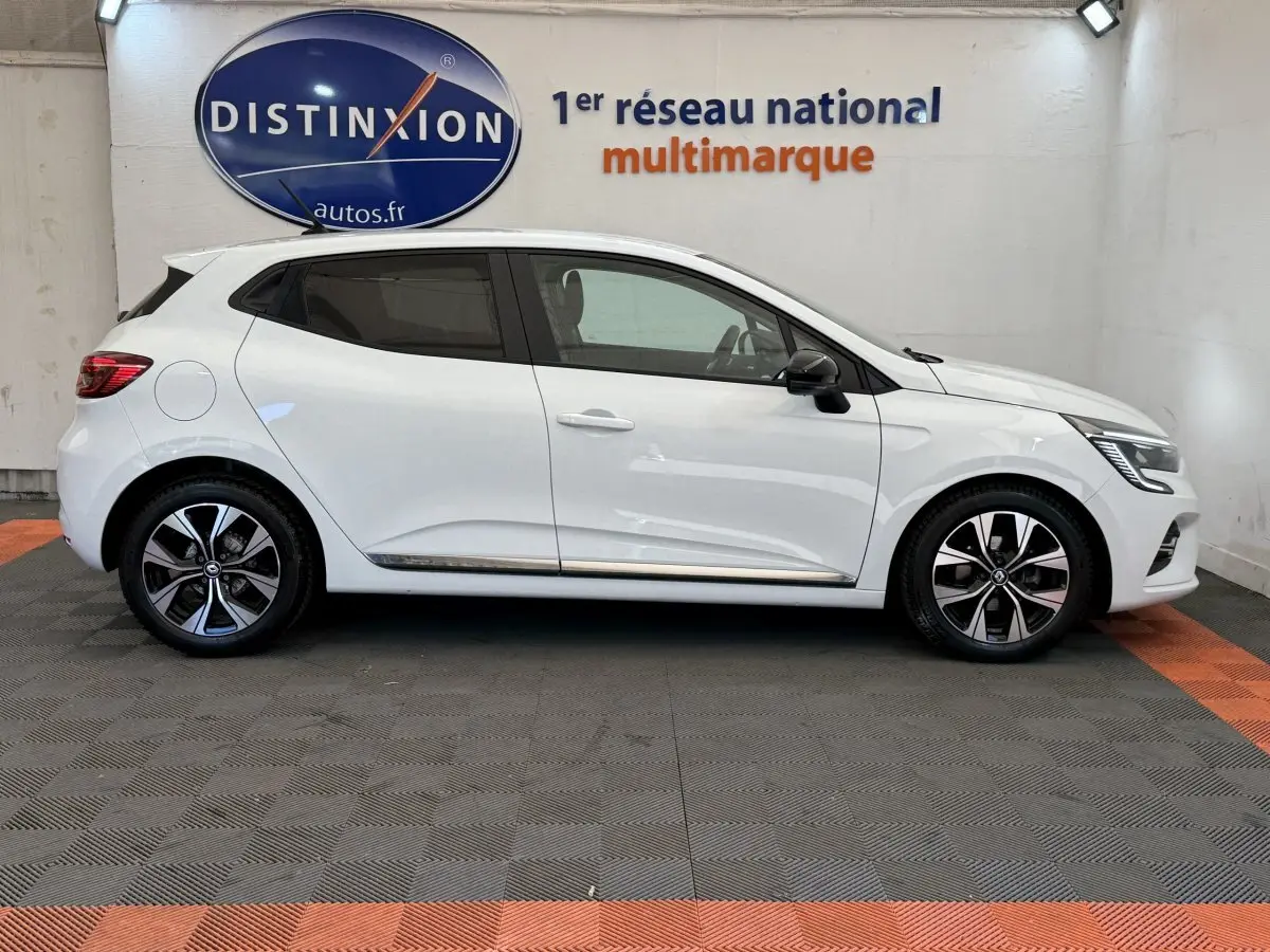 Profil droit de la Renault Clio Evolution TCe 100 GPL blanche, avec jantes alliage et rétroviseurs noirs.