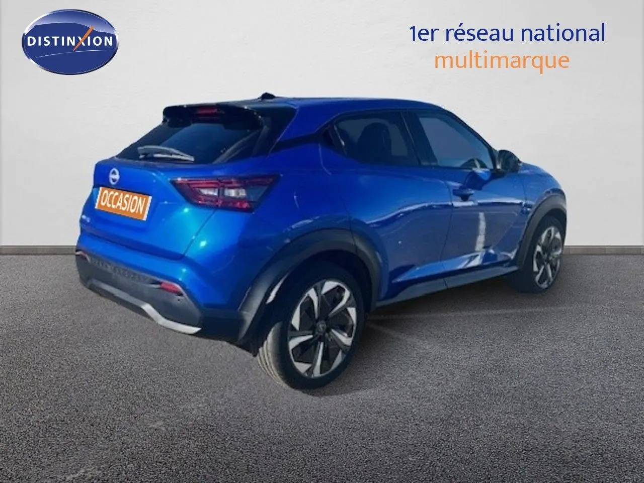 Nissan Juke bleu magnétique métal en 3/4 arrière droit, avec jantes alliage et feux arrière LED distinctifs.