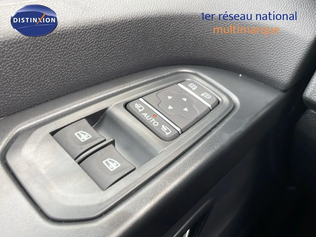 Panneau de commandes des vitres électriques côté gauche dans l'habitacle du Renault Trafic Fourgon blanc glacier.