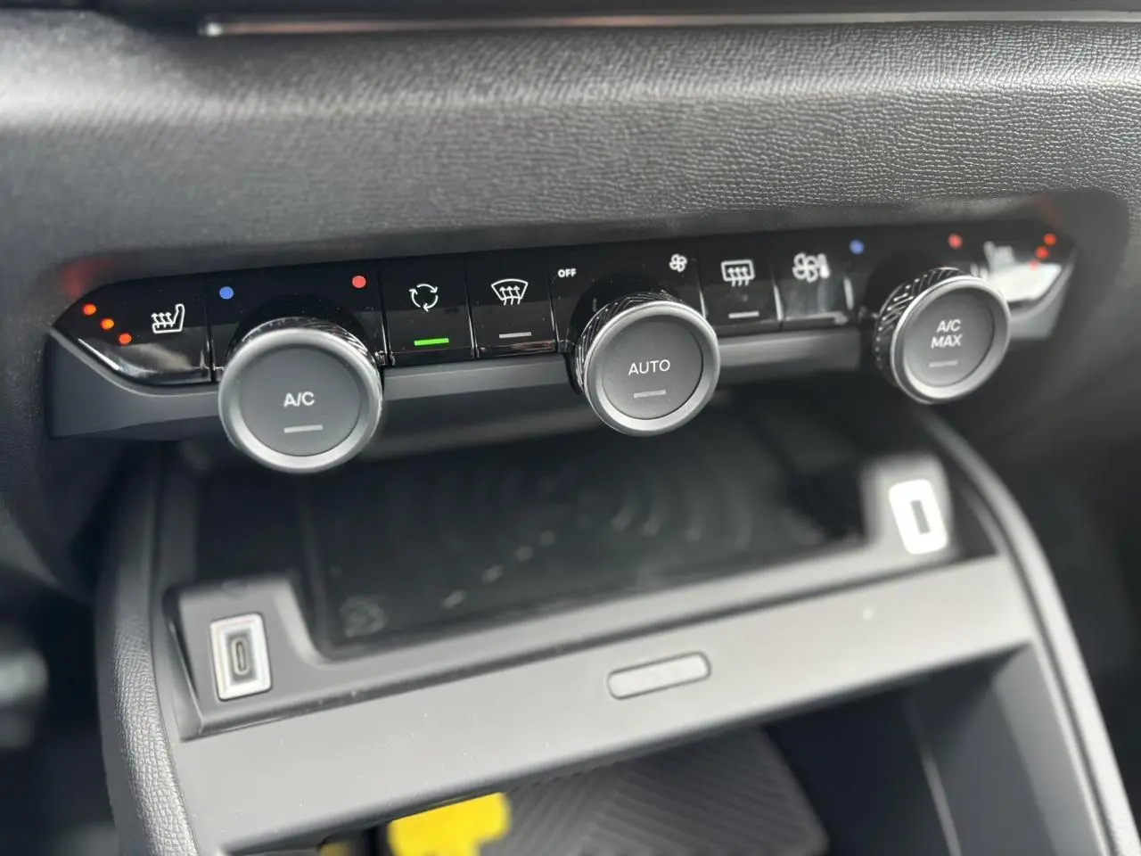 Gros plan sur les commandes de climatisation automatique de la Citroën C4 PureTech 130, finition Alcantara, intérieur noir.