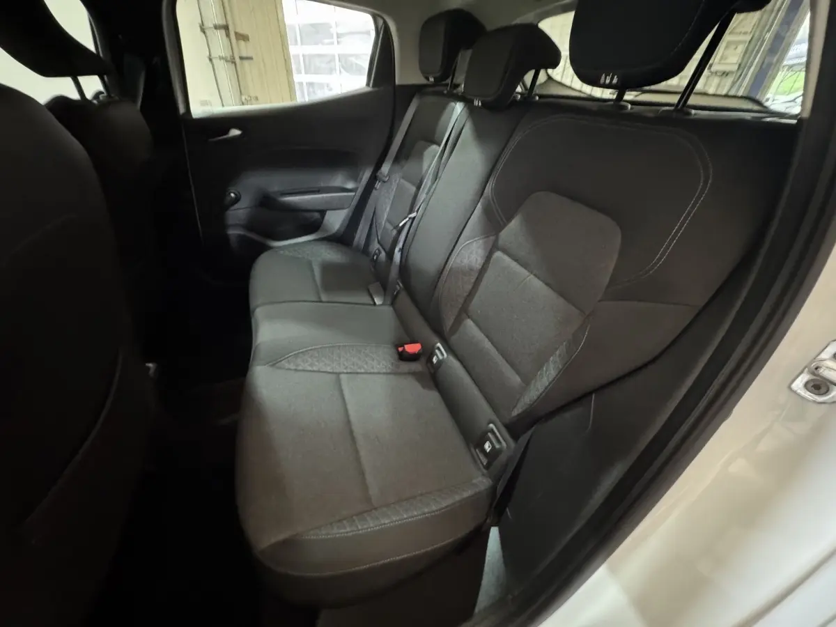 Vue côté droit des sièges arrière noirs de la Renault Clio Business TCe 100 blanche de 2020, portes ouvertes.