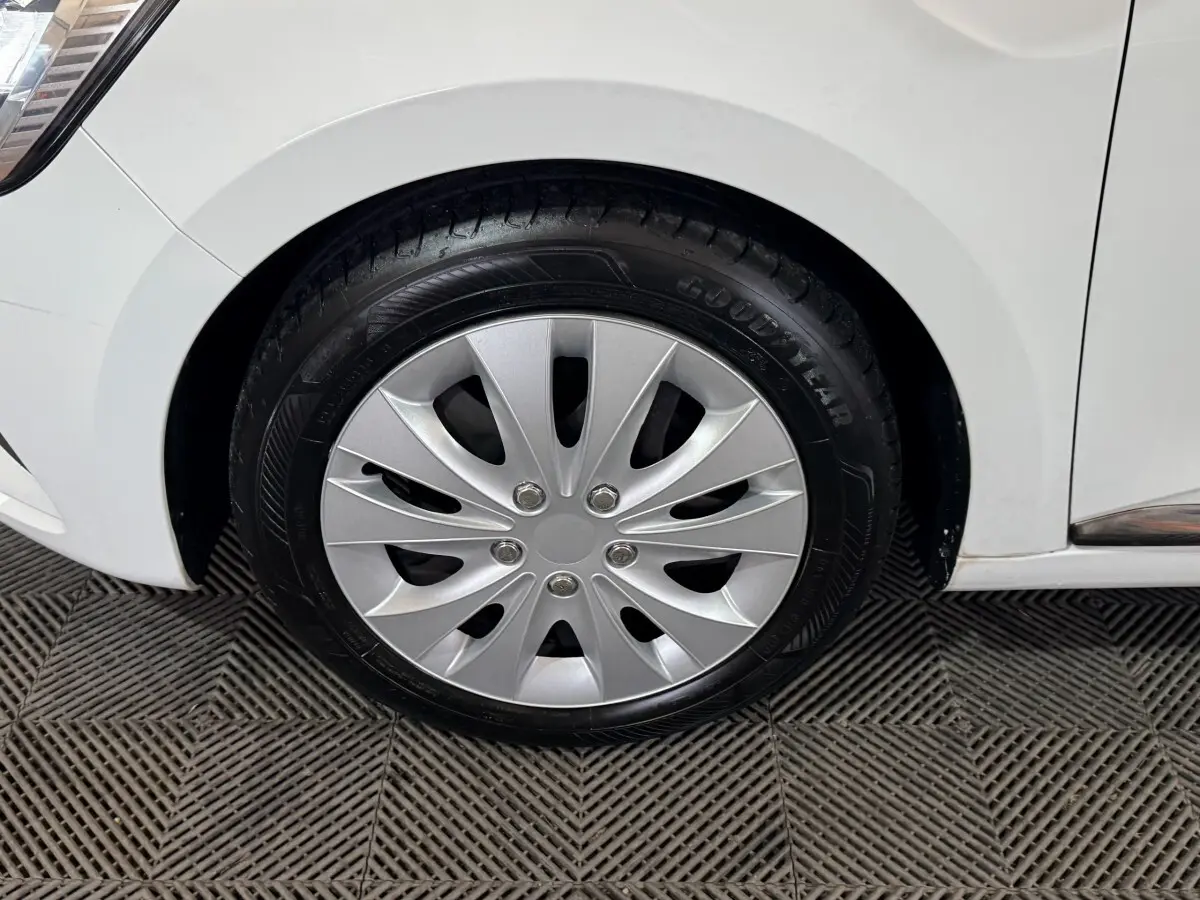 Gros plan sur la roue avant droite d'une Renault Clio Business TCe 100 blanche, avec jante en alliage argenté.