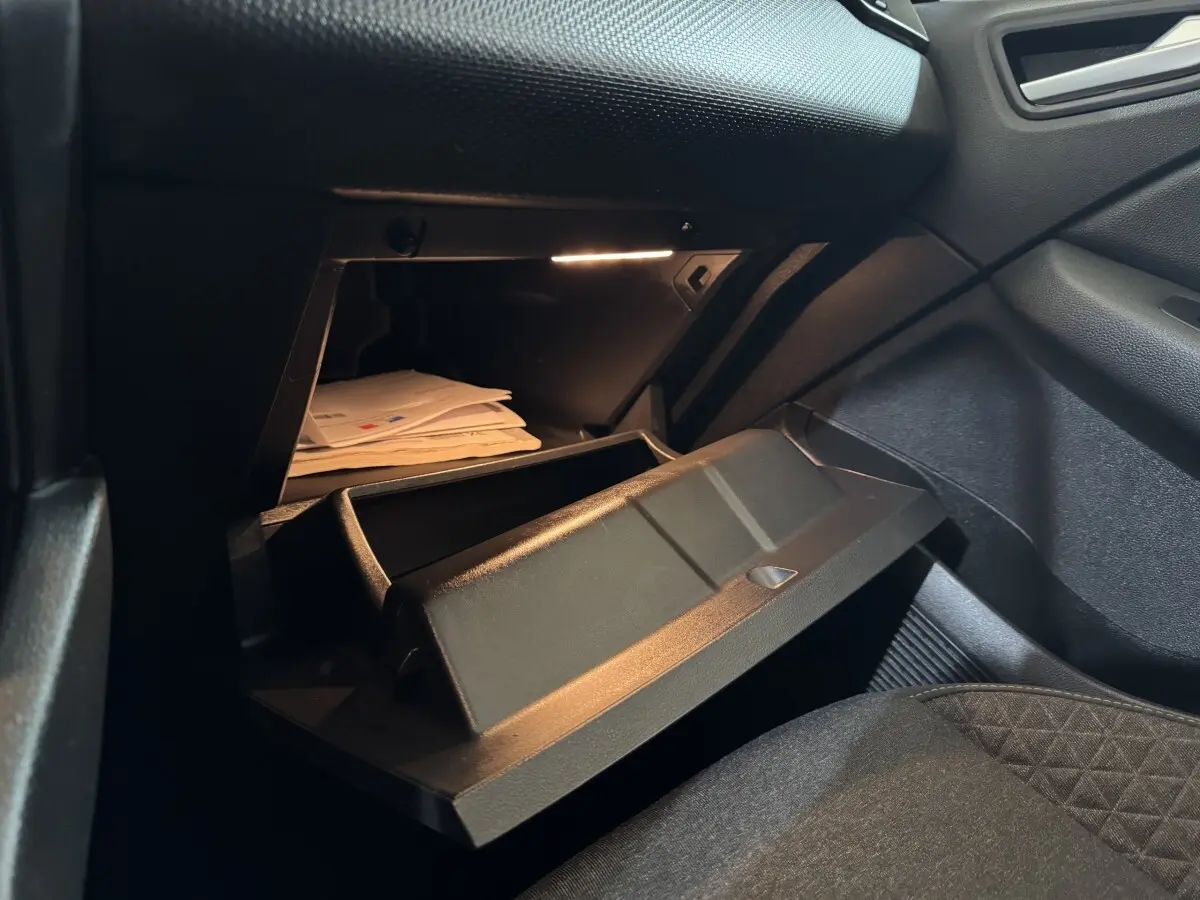 Vue intérieure côté passager de la boîte à gants ouverte de la Renault Clio Business TCe 100 blanche de 2020.