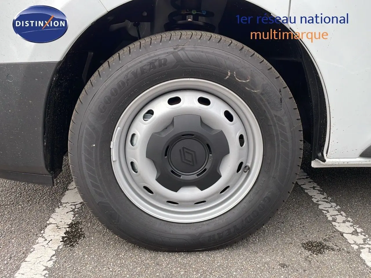 Gros plan sur la roue avant gauche du Renault Trafic Fourgon blanc glacier, avec jante acier et logo Renault central.